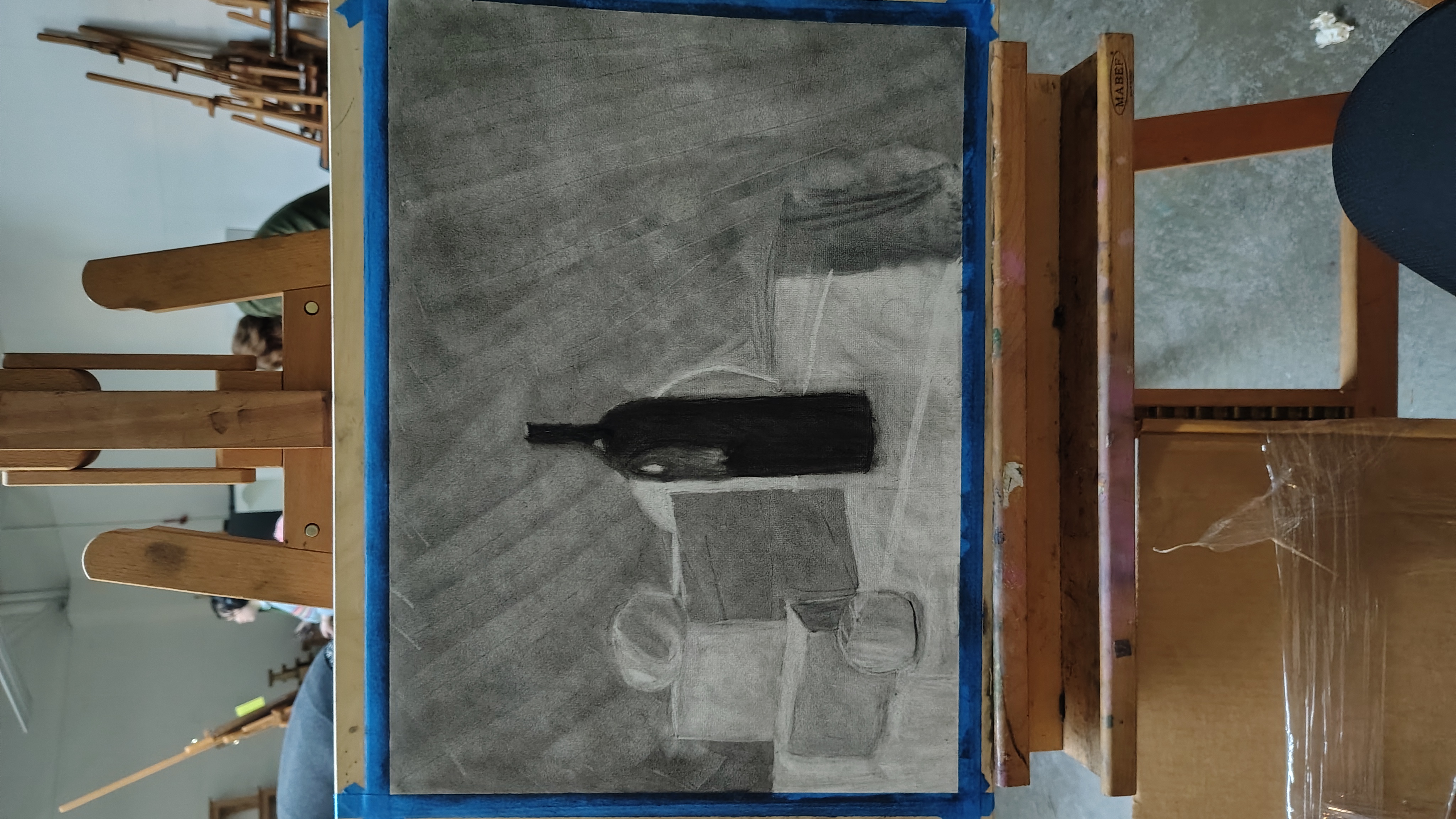 Graphite drawing of a black bottle still life